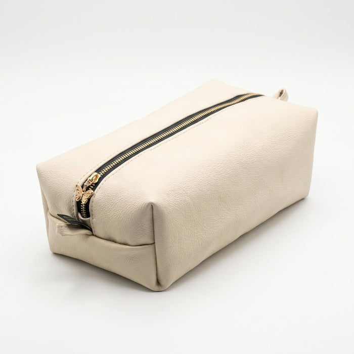 The Élise Beauty Bag in ivory with black zip and gold butterfly detail